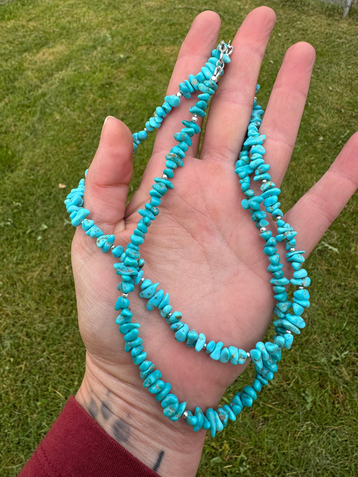 Beaded turquoise necklaces on hand