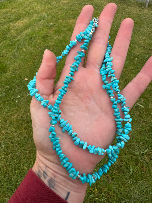 Beaded turquoise necklaces on hand
