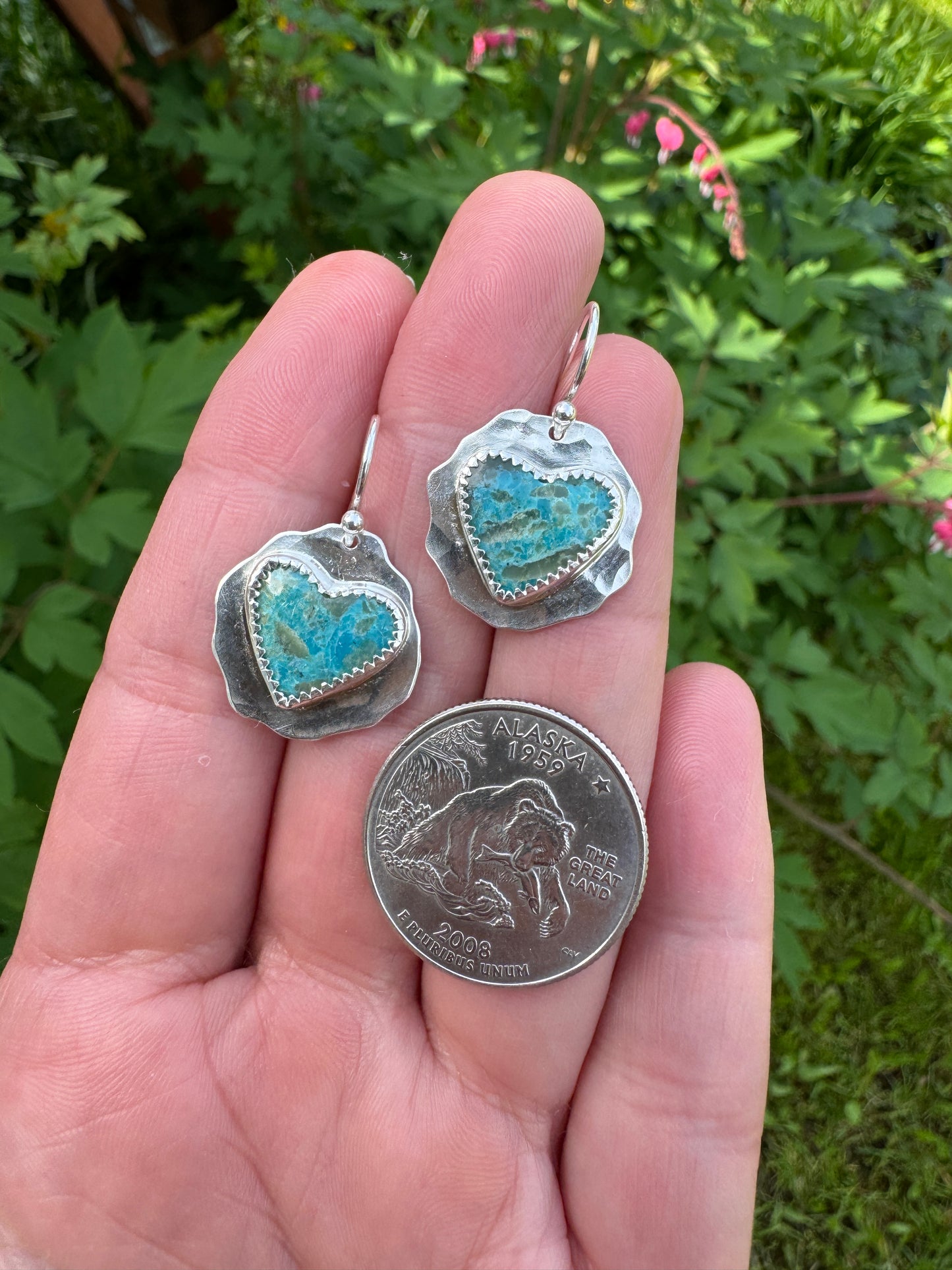 heart shaped Kingman turquoise earrings with hammered sterling silver backplate shown next to US quarter for scale