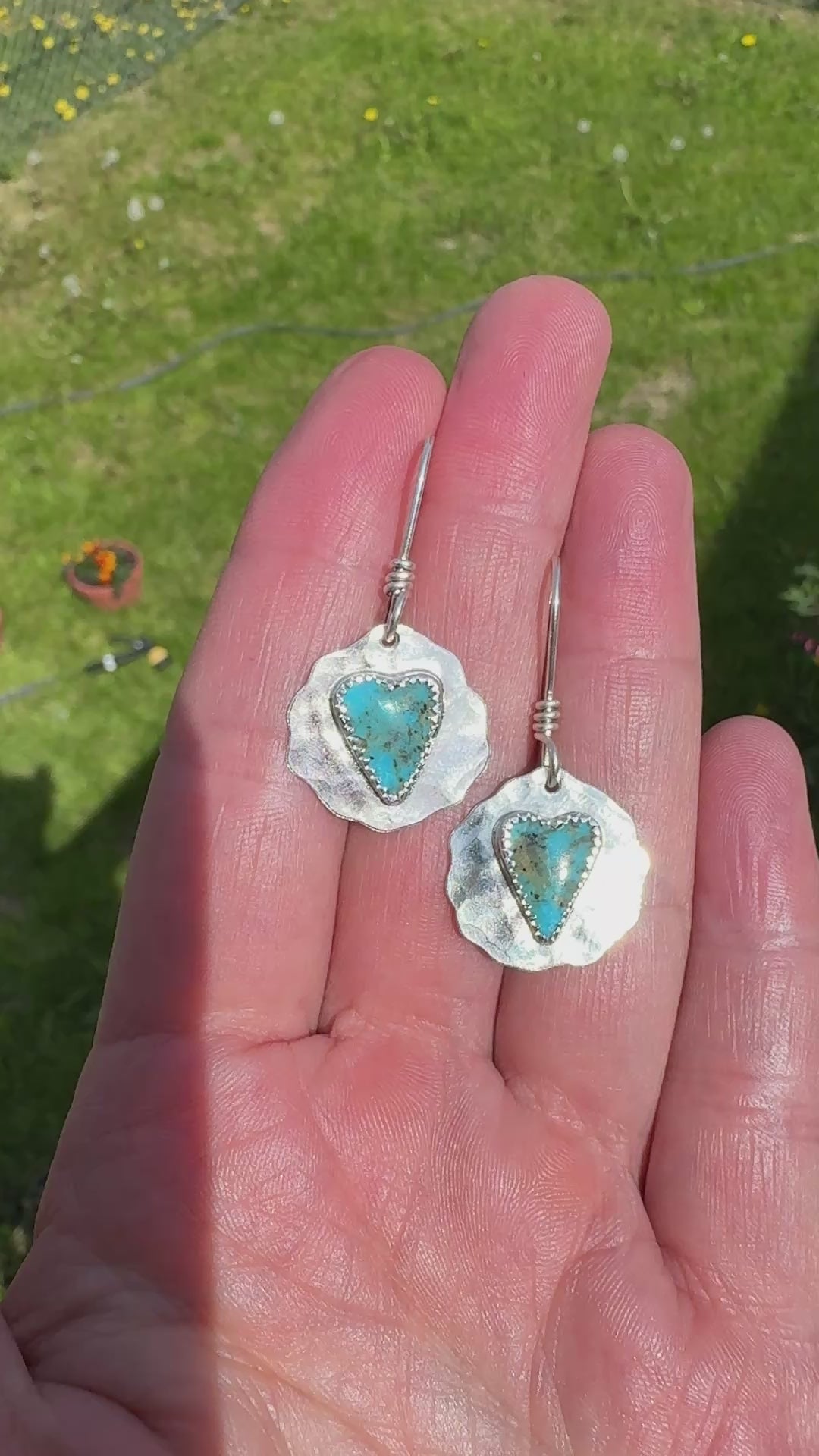 Video of slim heart-shaped Kingman turquoise bezel set in sterling silver on my hand showing them dangling. 